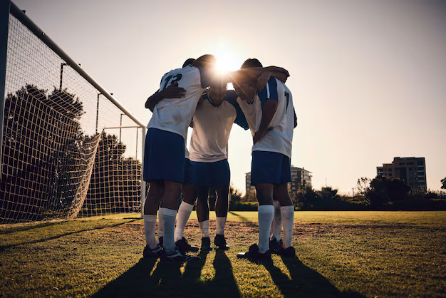 A soccer team gathers together on a field