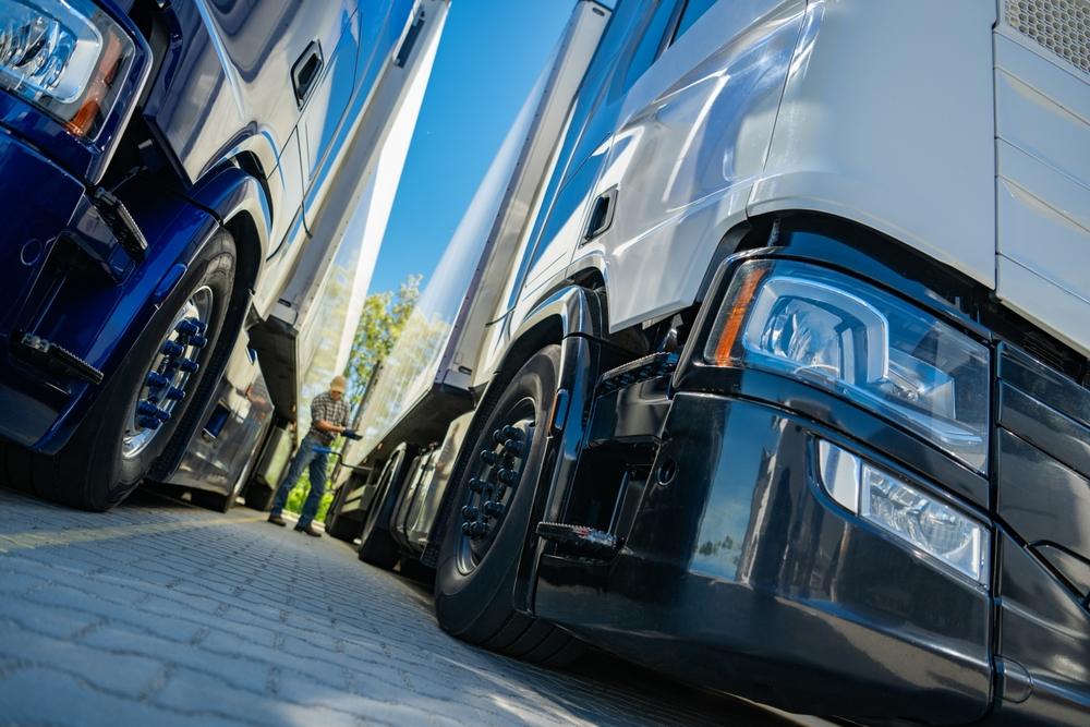 A truck inspector examines two trucks to determine whether they are considered commercial trucks in Washington.