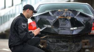 A police officer filling out a car crash report in Seattle, WA.