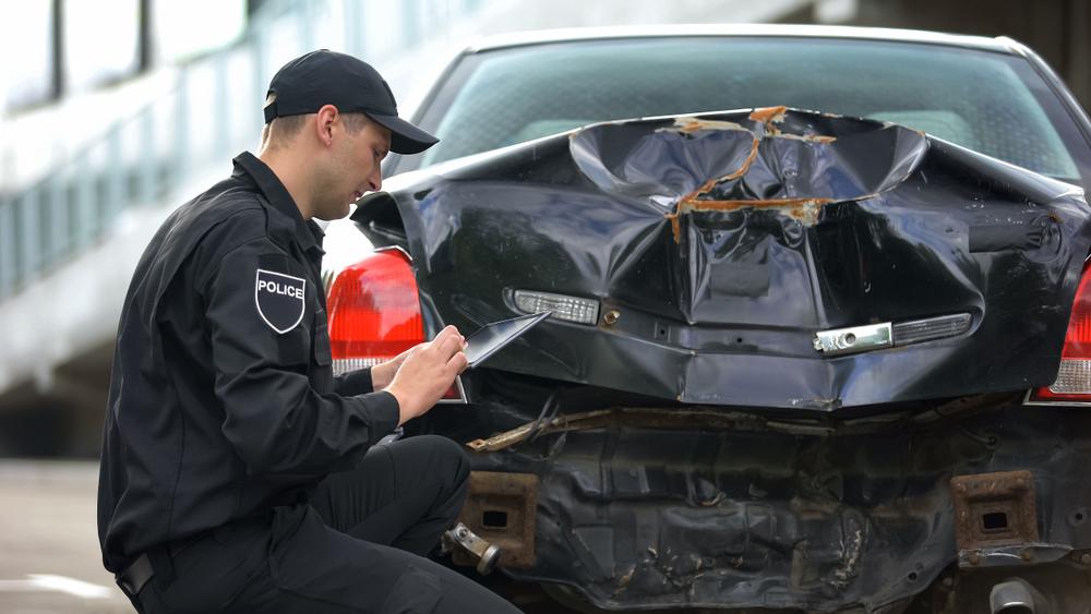 A police officer filling out a car crash report in Seattle, WA.
